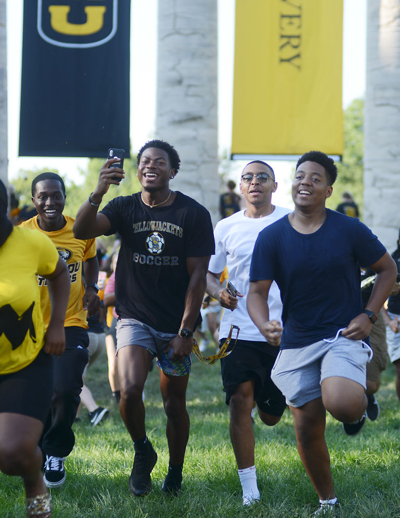 New MU students run through the columns for the annual Tiger Walk